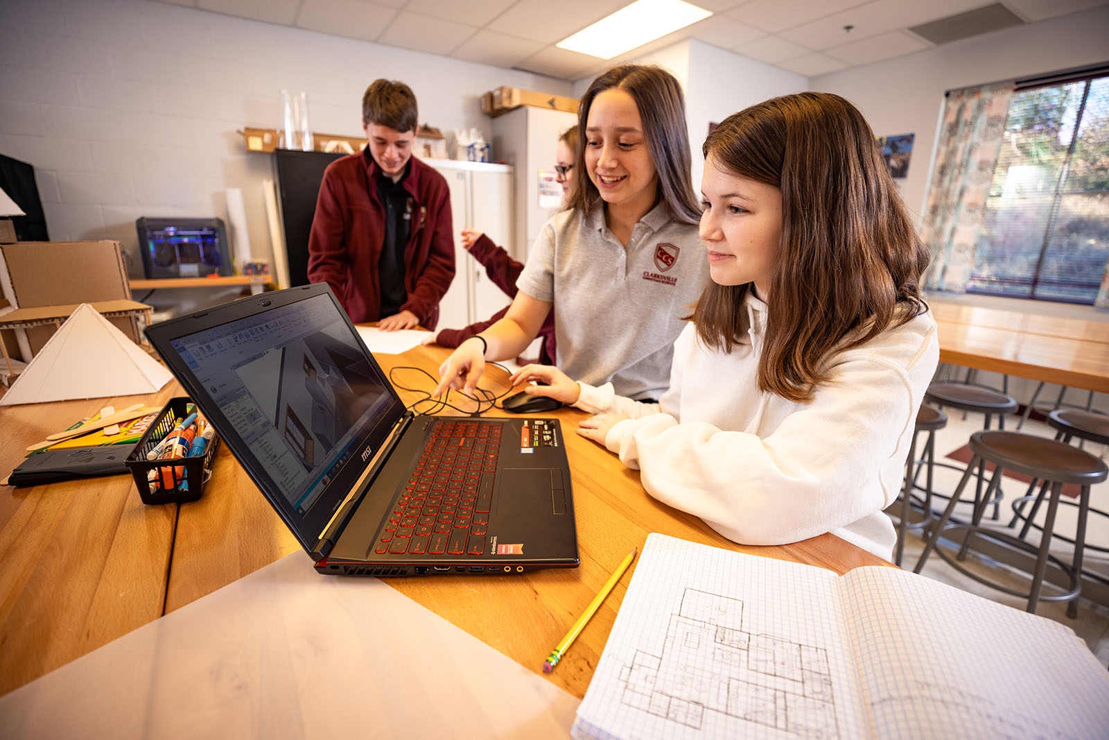 two girls working at computer in classroom