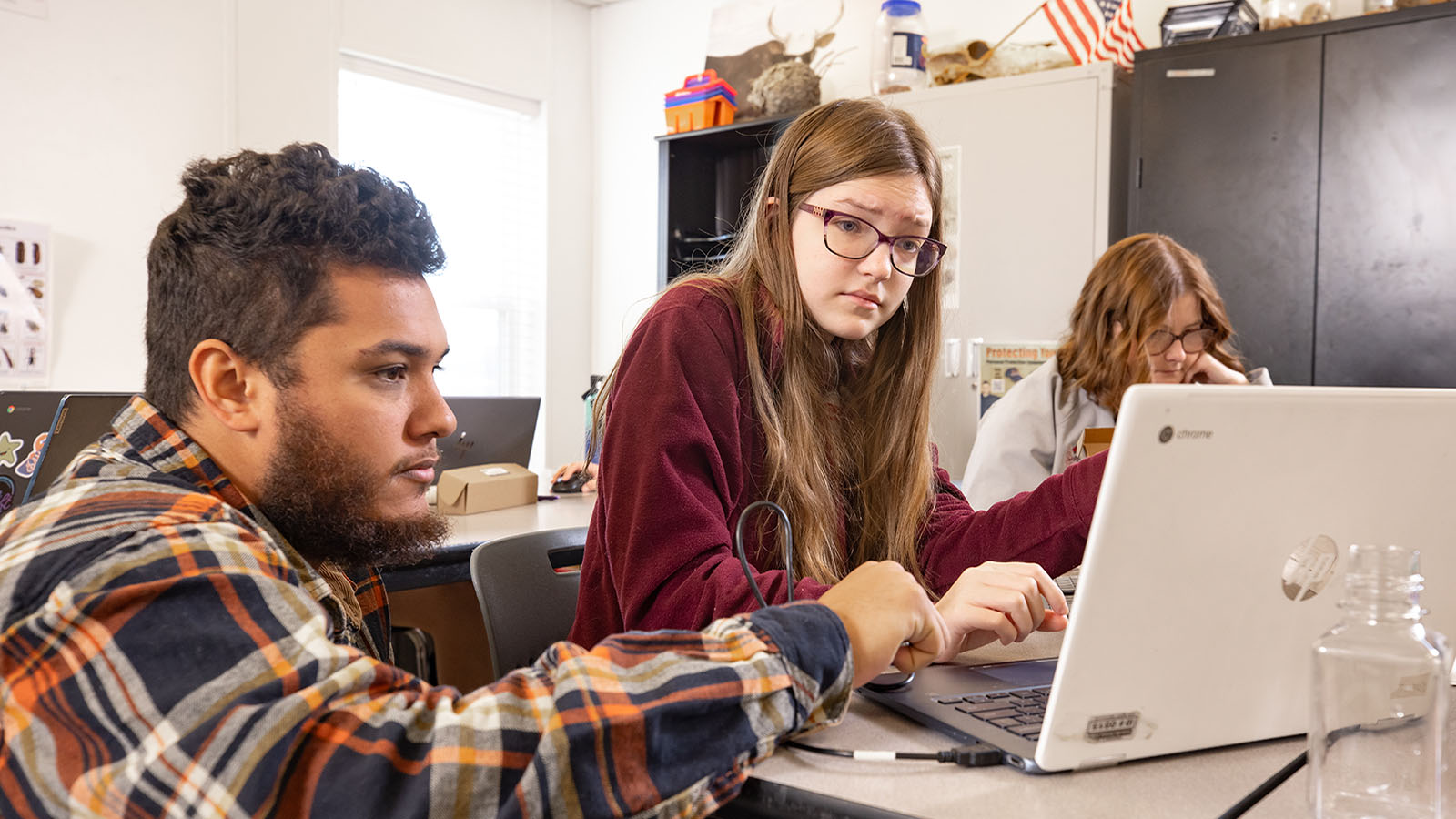 teacher and student looking at laptop