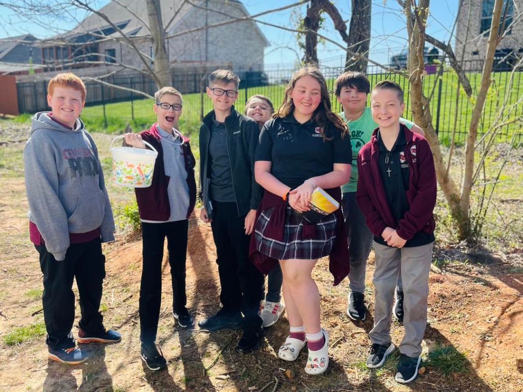 A group of students pose for a photo during an easter egg hunt