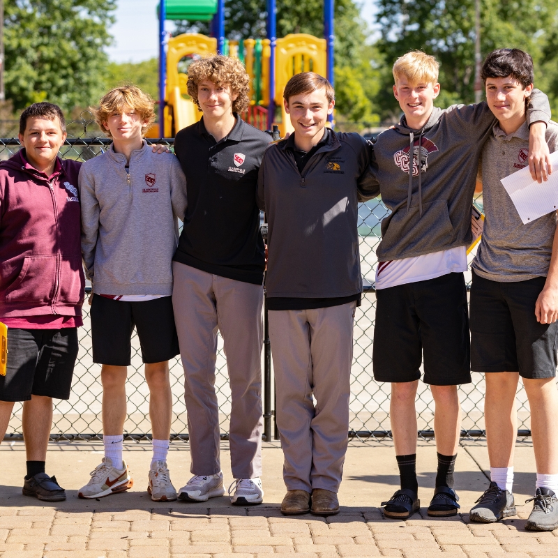 male students standing outside